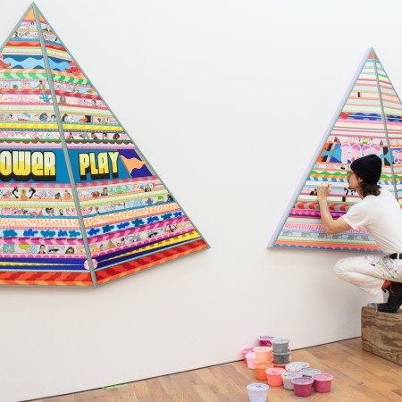 artist erik parker paints a set of two neon pyramids in his nyc studio
