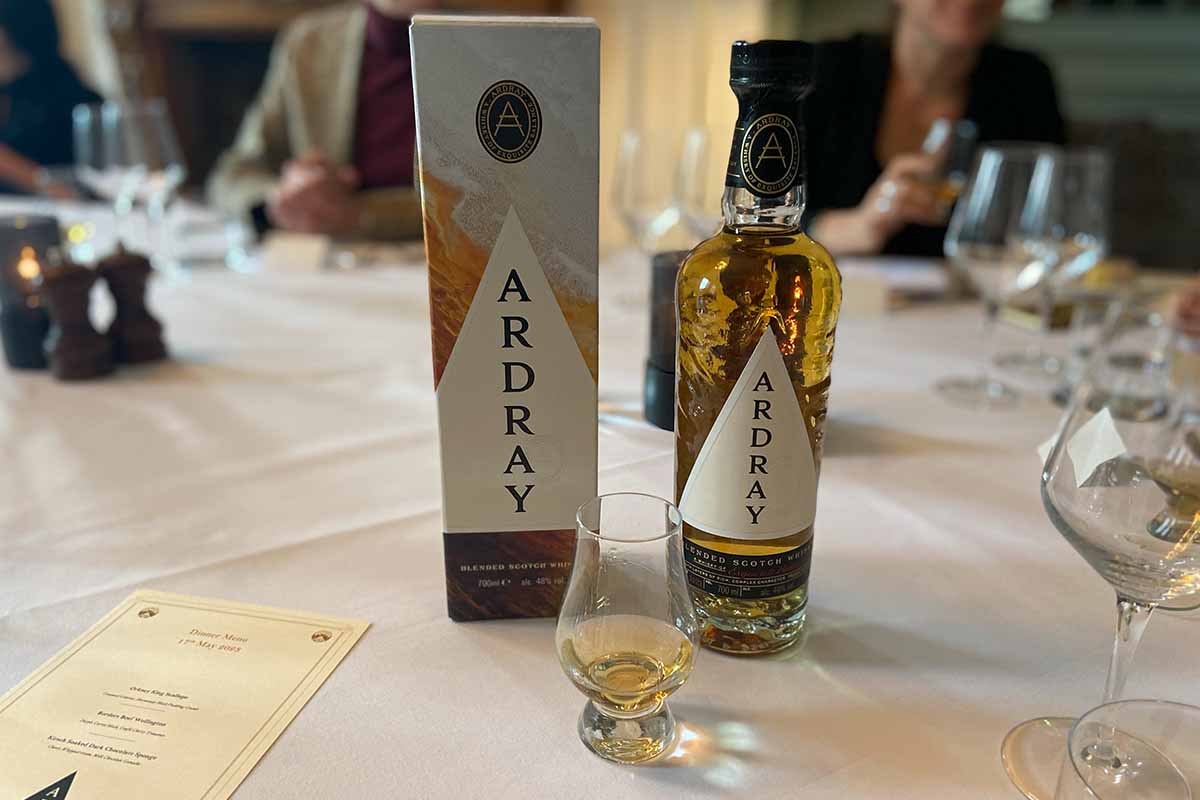 A close-up of the Ardray bottle, box and a neat pour