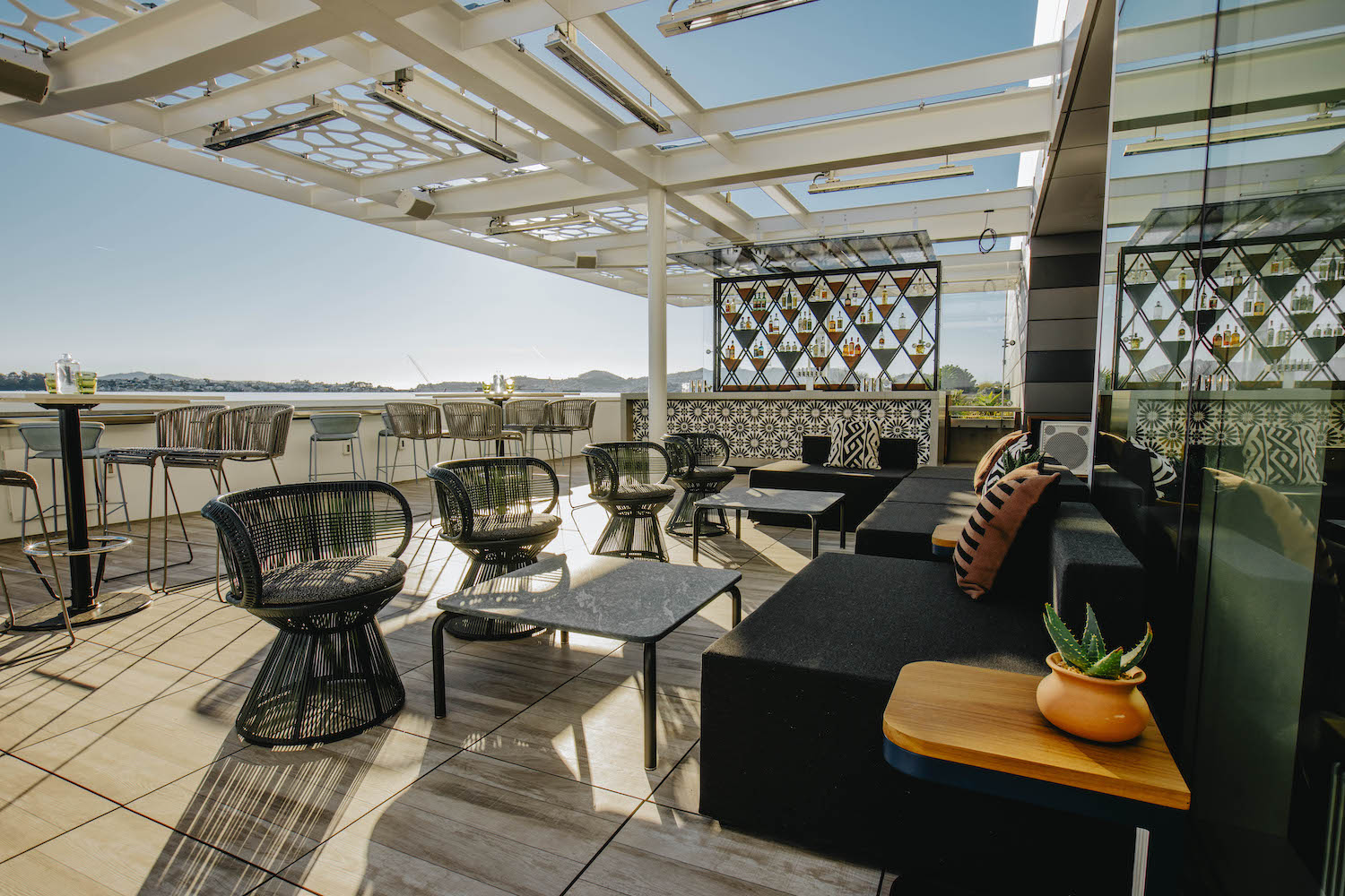 scenic black-and-white decorated outside rooftop area overlooking the water.