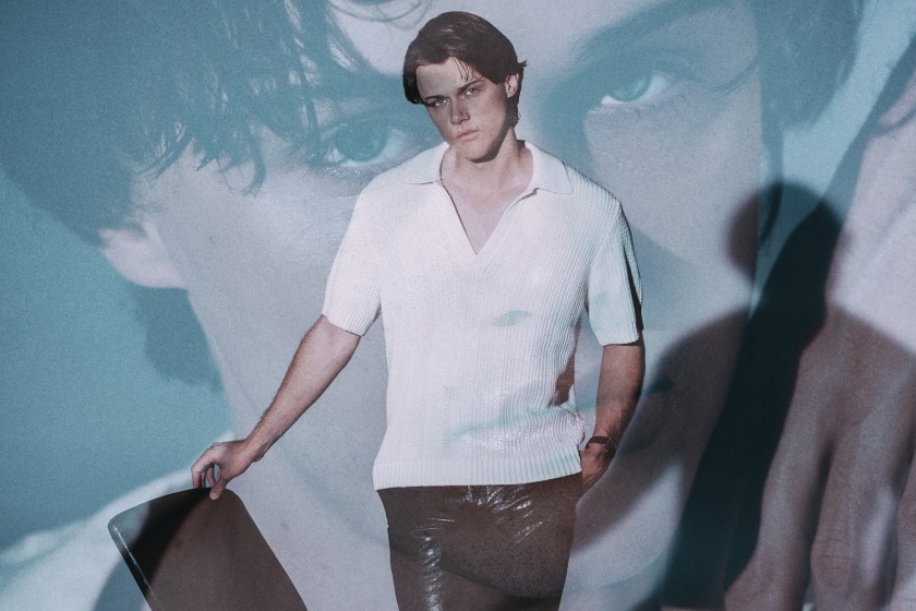 a photo of Chris Briney in a white jacket and black tank top on a white background