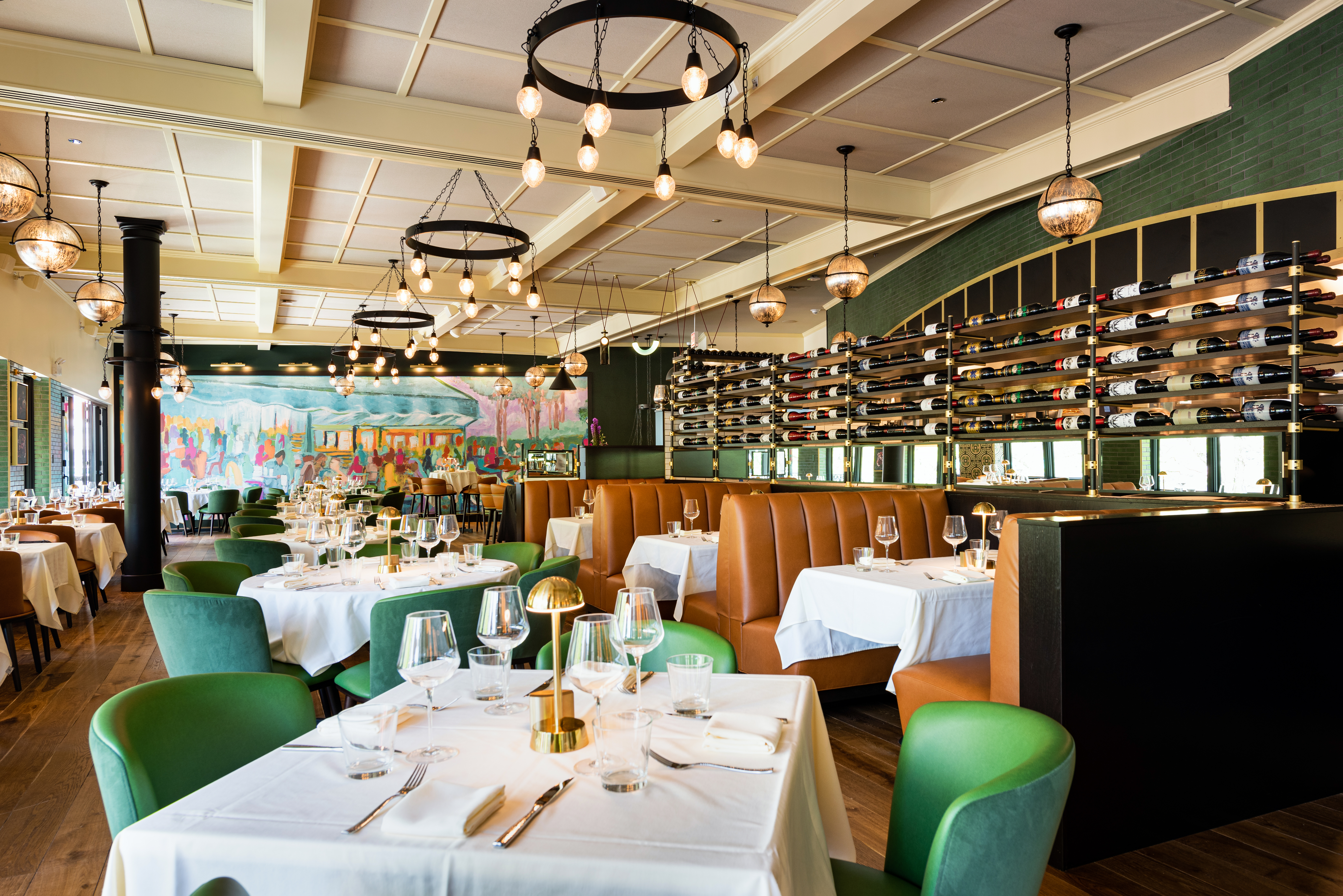 Lively dining room with green and brown seating.
