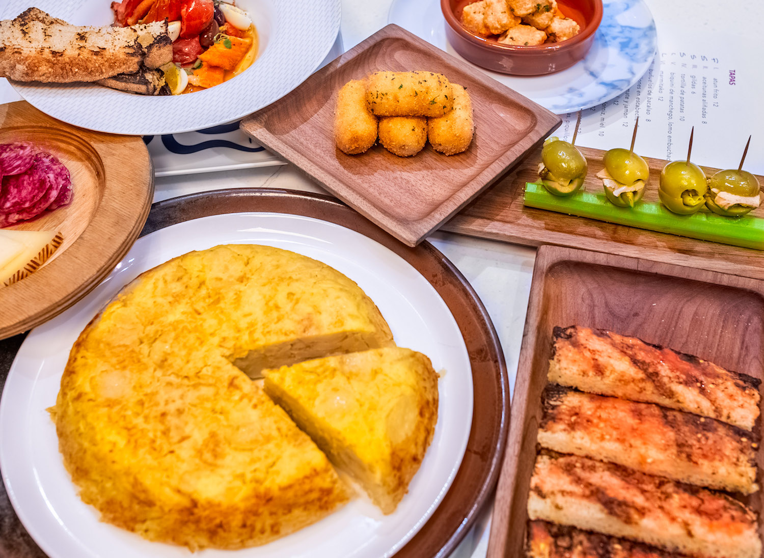 a spread of Spanish cuisine on a table.