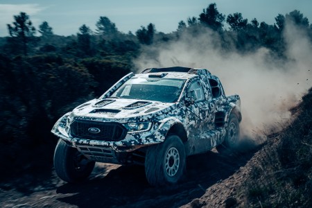 Ford Raptor driving on a dirt road.