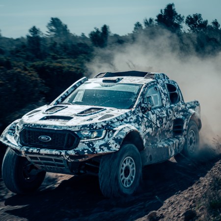 Ford Raptor driving on a dirt road.