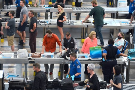 Airplane passengers proceed through the TSA security checkpoint at Denver International Airport