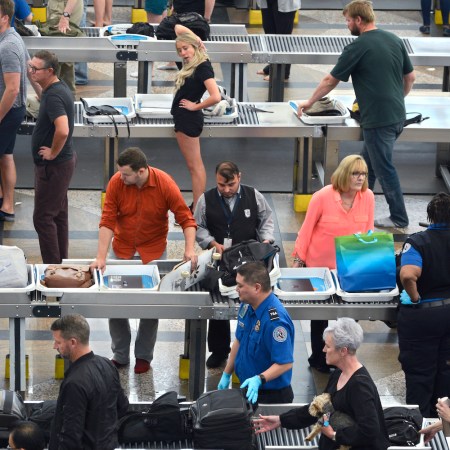 Airplane passengers proceed through the TSA security checkpoint at Denver International Airport