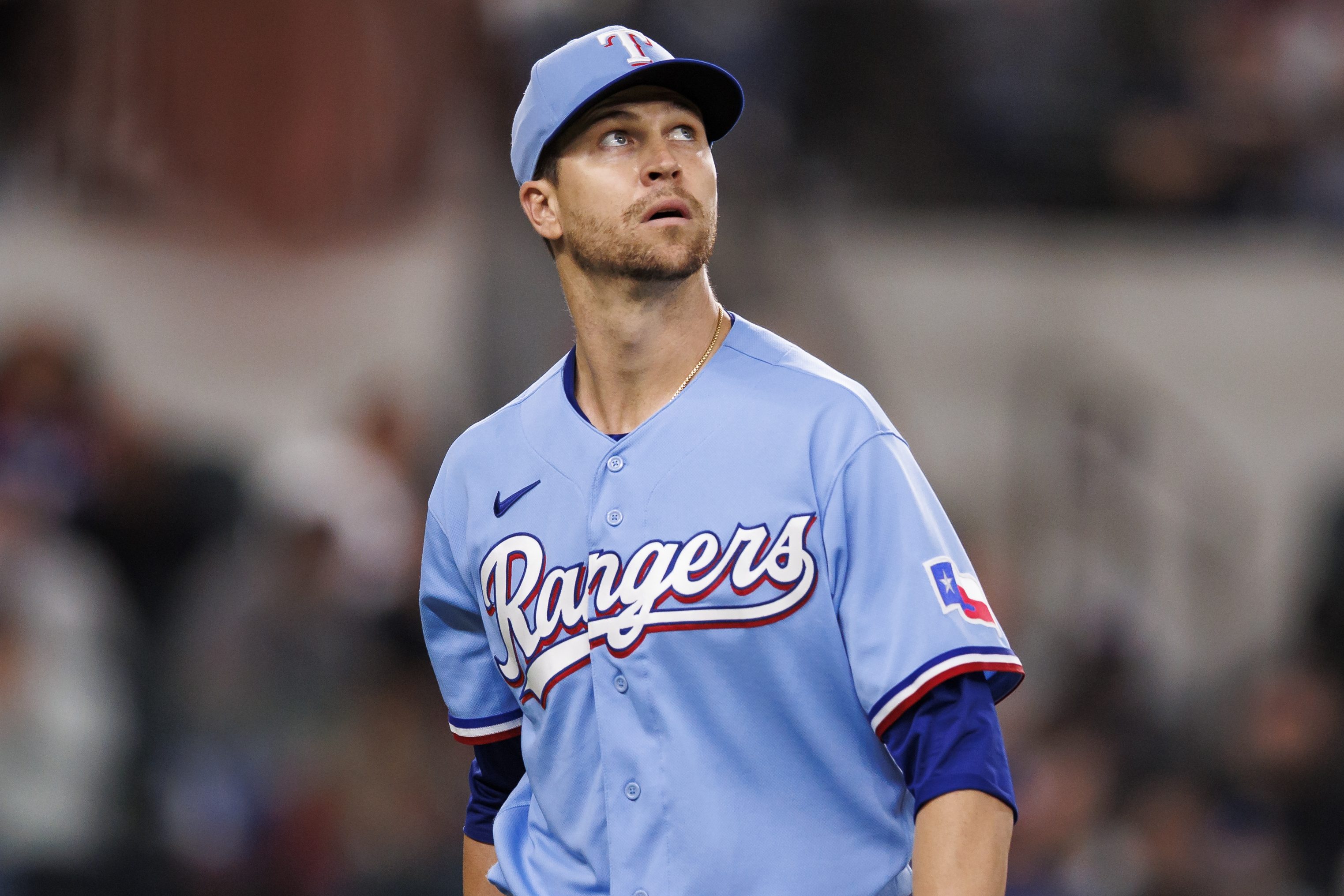 Jacob deGrom of the Texas Rangers returns to the dugout.