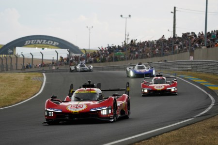 cars racing on race track.