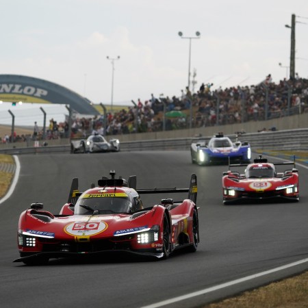 cars racing on race track.