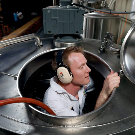 Dane Volek cleans a brew kettle at Anchor Public Taps on May 2, 2019.