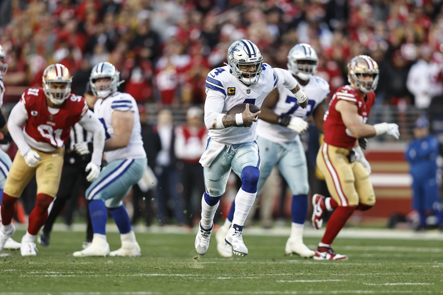 Dak Prescott scrambles and runs with the ball.