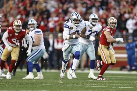 Dak Prescott scrambles and runs with the ball.