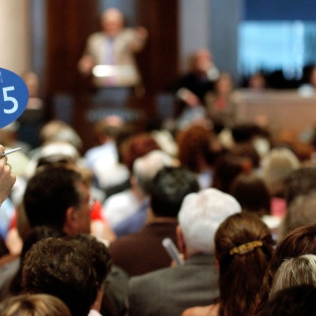 A bidder holds up his bidding sign during the Katharine Hepburn auction at Sotheby's June 10, 2004 in New York City.