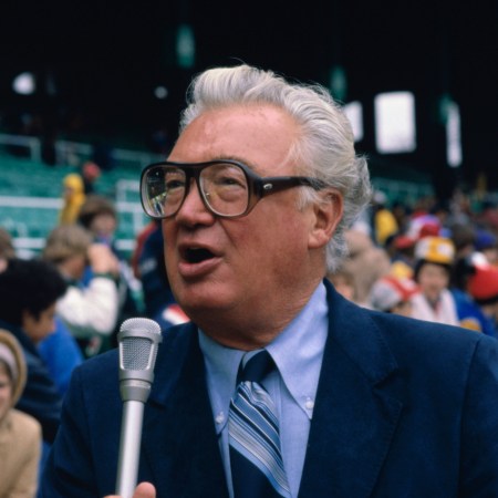 announcer Harry Caray talking into a microphone.