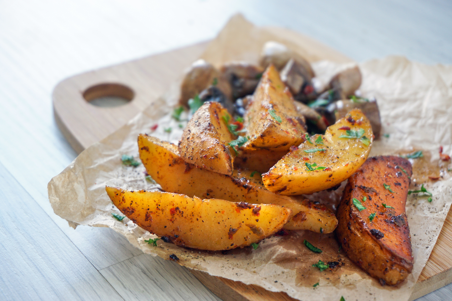 Baked potato and mushroom slices on wooden table