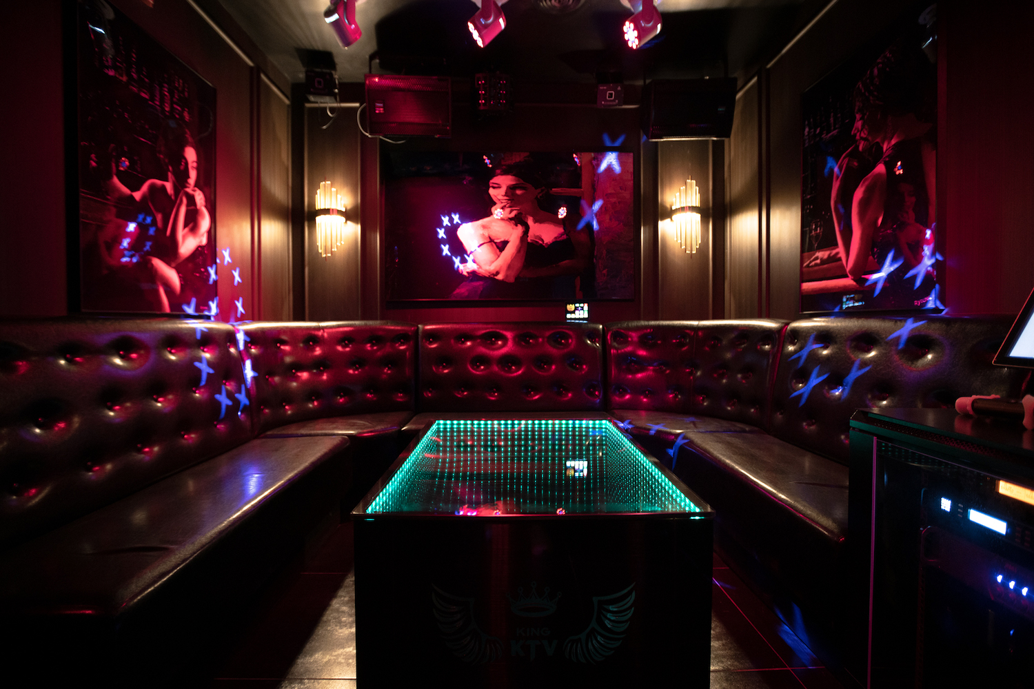 Dimly lit room with neon colors/black lights.