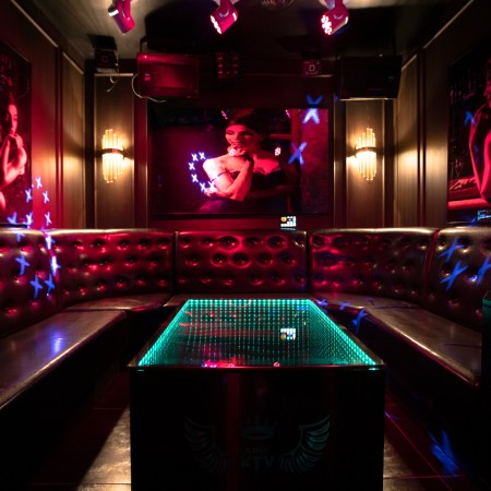 Dimly lit room with neon colors/black lights.