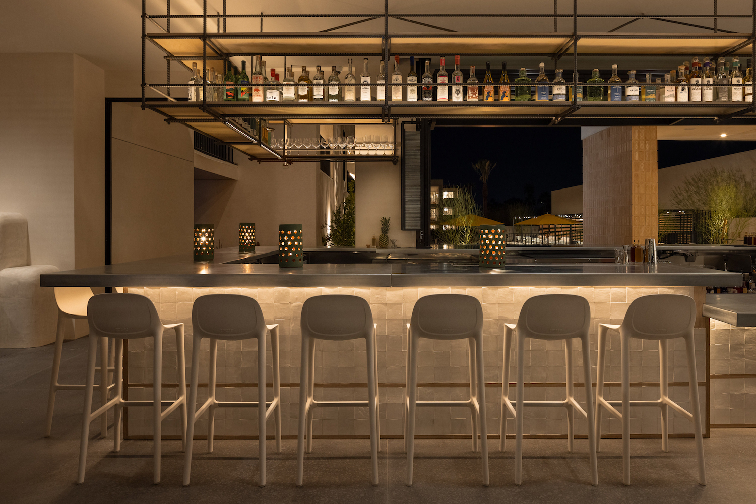 tan-colored seating at a bar with dim lighting.