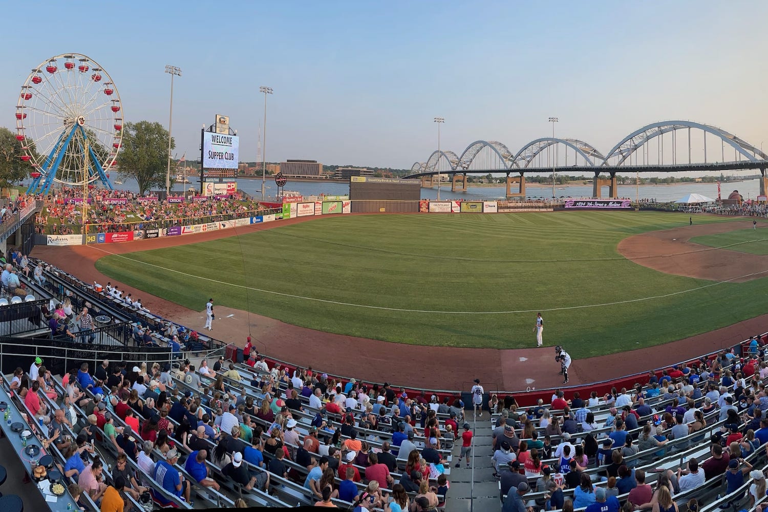 baseball field overlooking ferris wheel and bridge