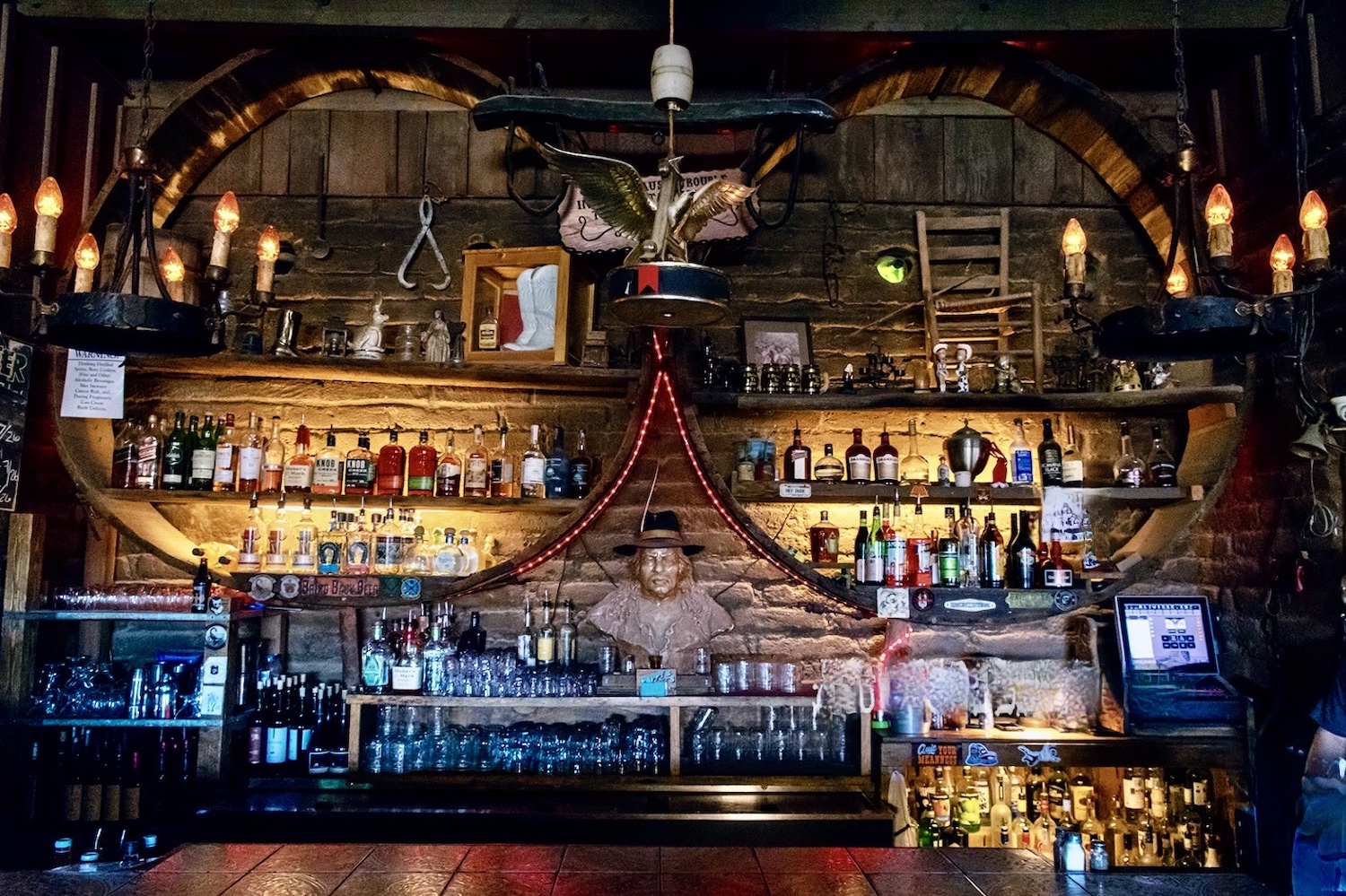 bar with artistic structure and bottles behind it