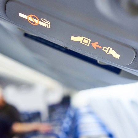 Fasten Seat belt sign and No Smoking sign on a plane