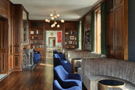 Blue chairs at tables in a library.