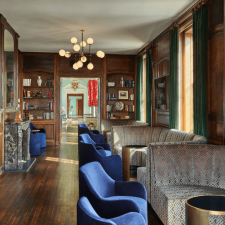 Blue chairs at tables in a library.