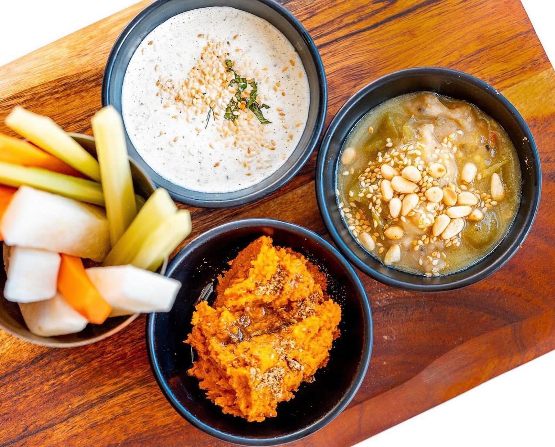 three dip cups on a plate