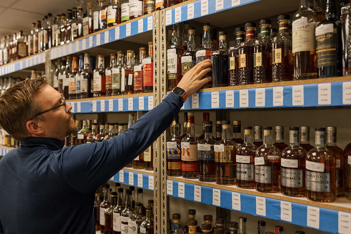 USC's Troy Clarke in front of several of judged samples at the Ultimate Spirits Challenge 2023
