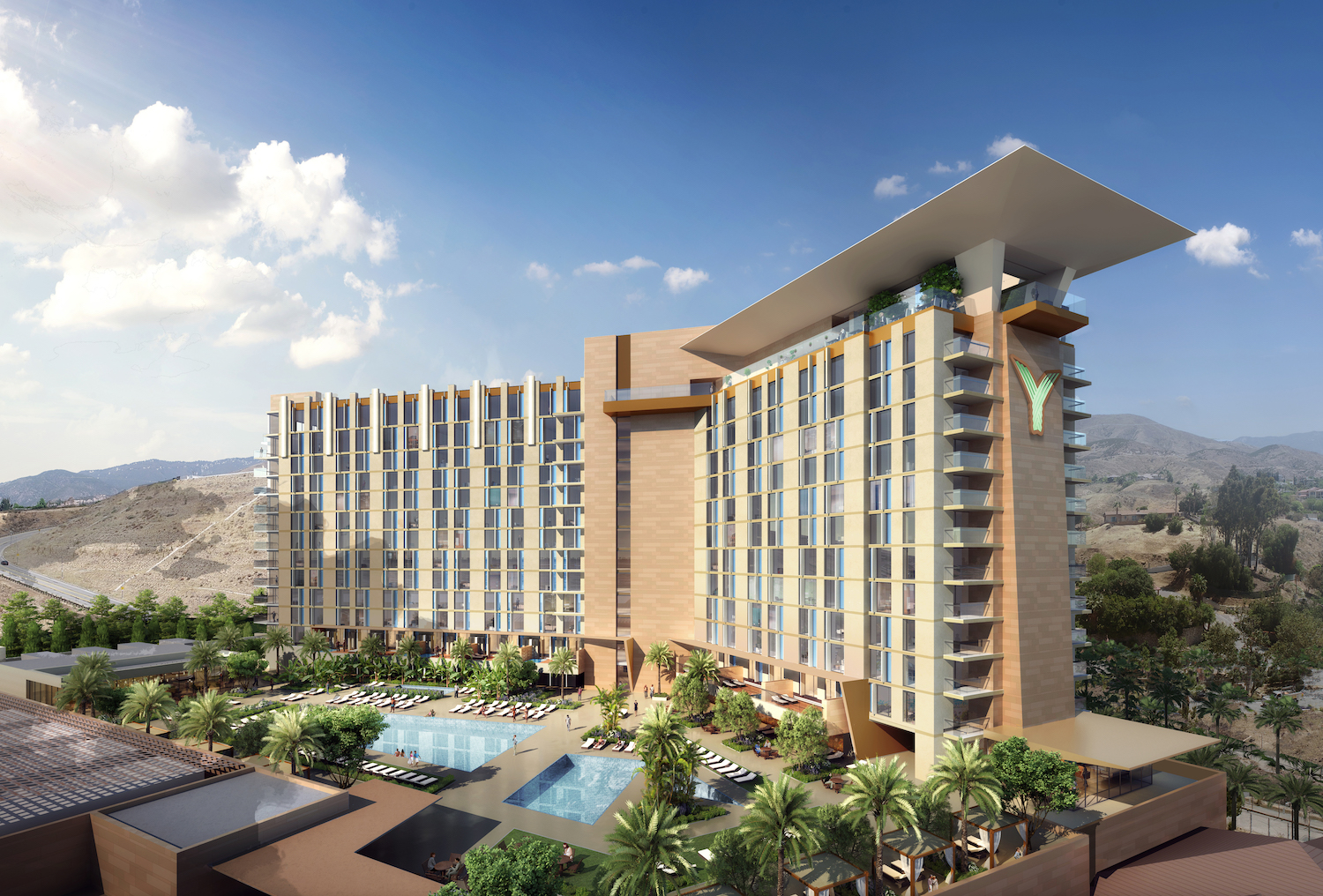 large hotel building with pool below it.