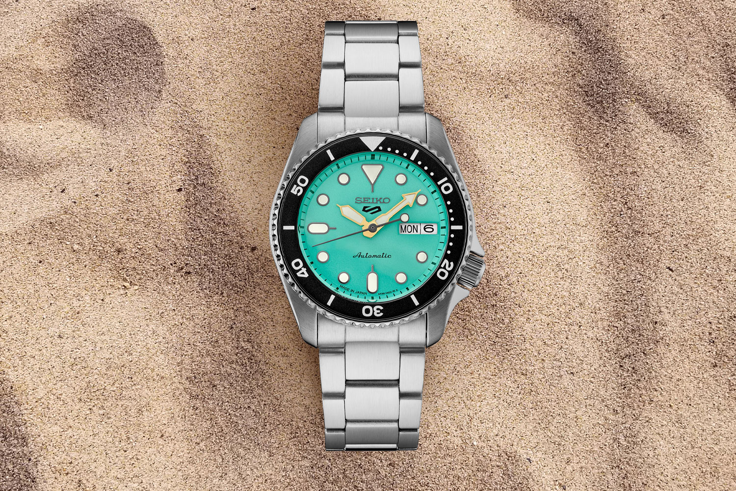 watch on the sand.