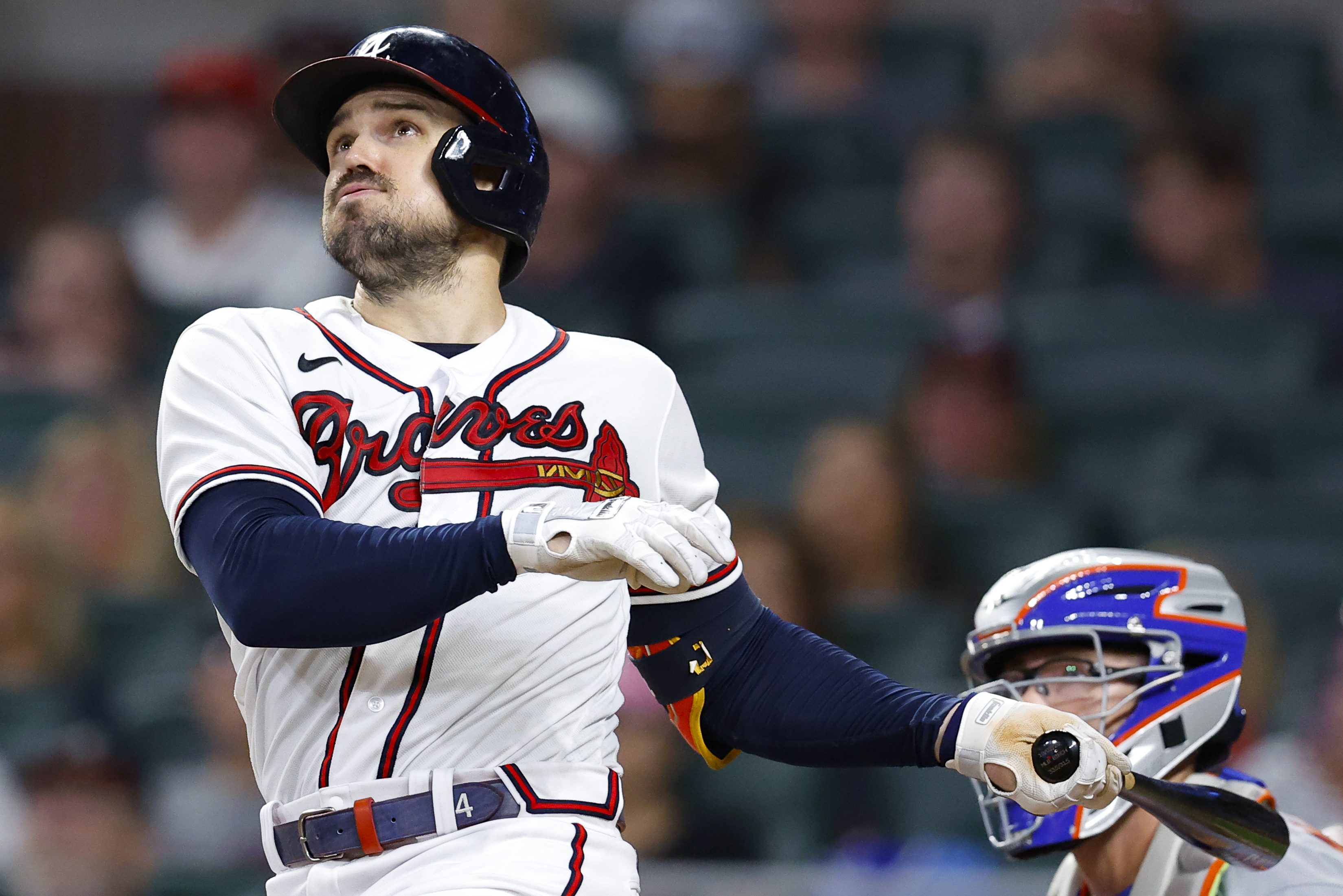 Adam Duvall watches the ball after hitting a homer.