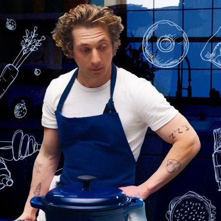 carmy from the bear wearing a blue apron and white tee shirt