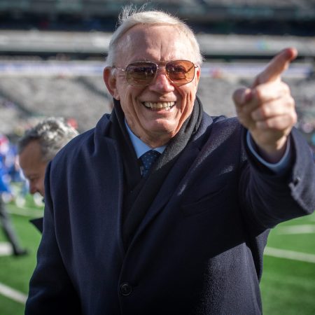 Cowboys owner Jerry Jones on the field reacting to fans.