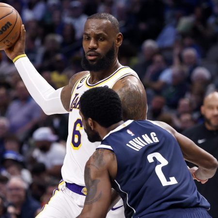 LeBron James handles the ball against Kyrie Irving of the Mavericks.