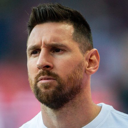 Lionel Messi warms up before a French league soccer match.