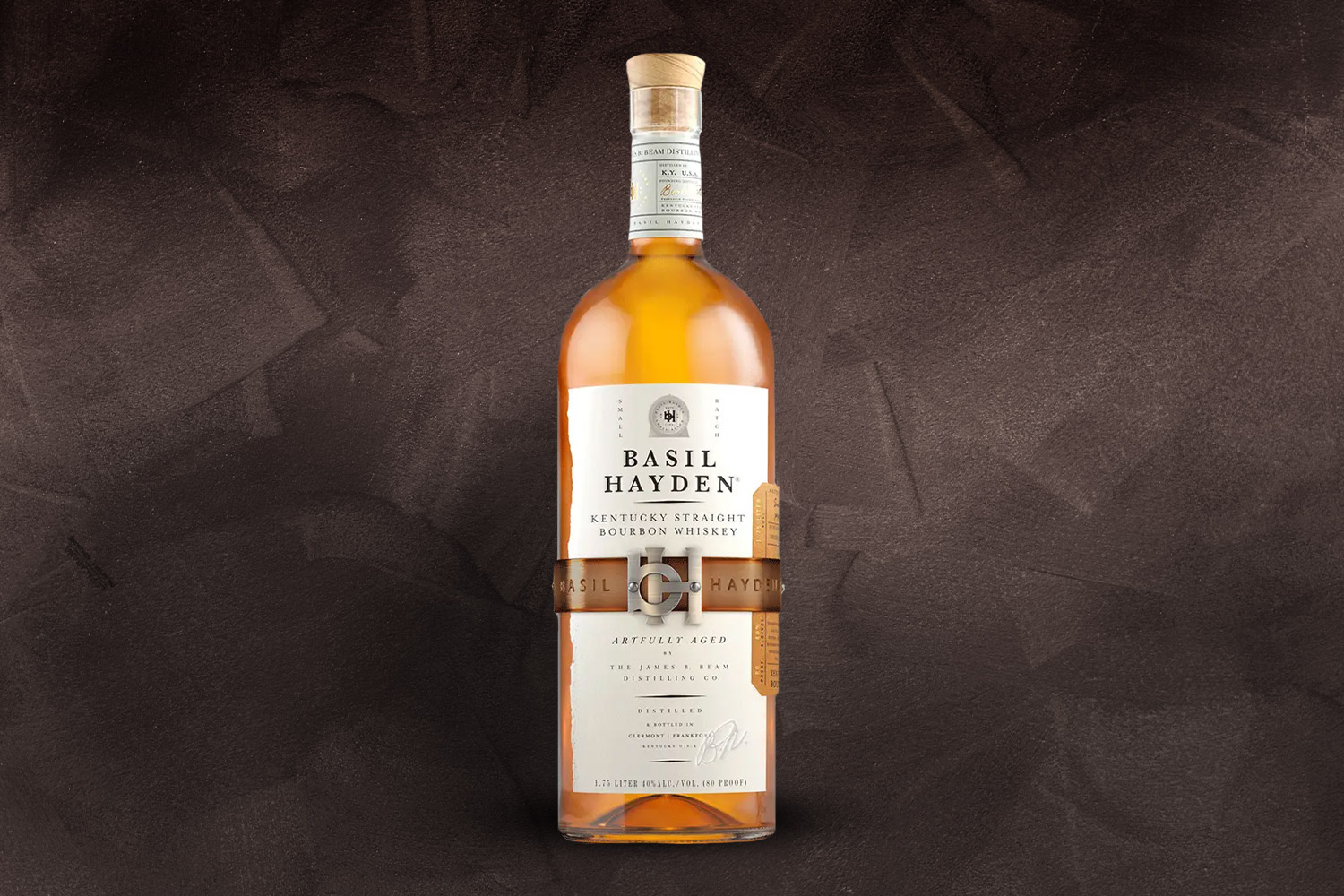 a bottle of basil hayden bourbon on a grey background