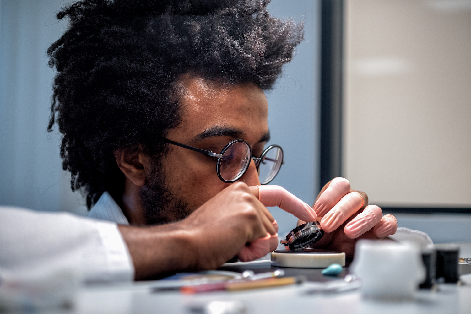 Close-up of person making a watch.