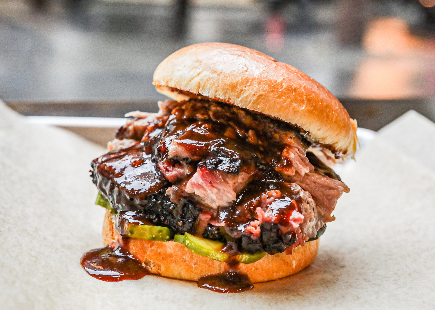 Burger with sauce dripping down the sides.