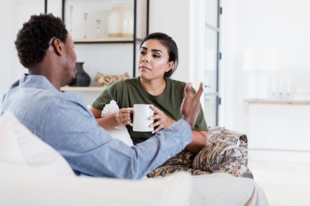 An attentive female soldier listens as her husband discusses something serious