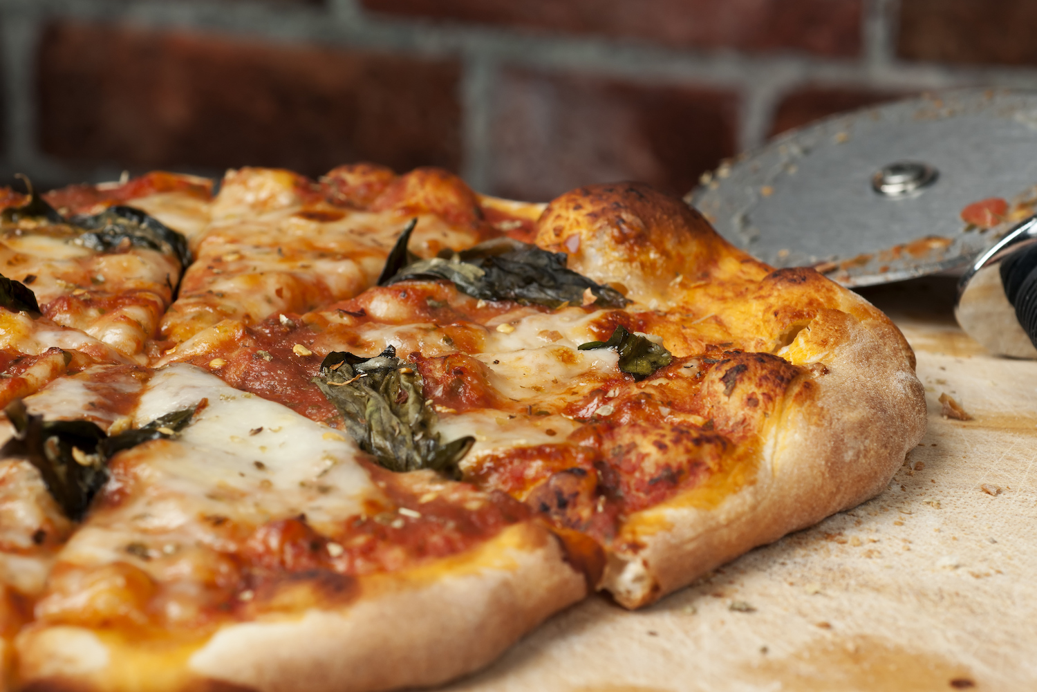 Margharita Pizza with brick oven and pizza slicer
