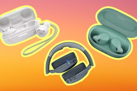 Wireless gym headphones on an orange and pink background