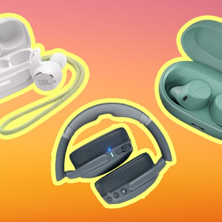 Wireless gym headphones on an orange and pink background