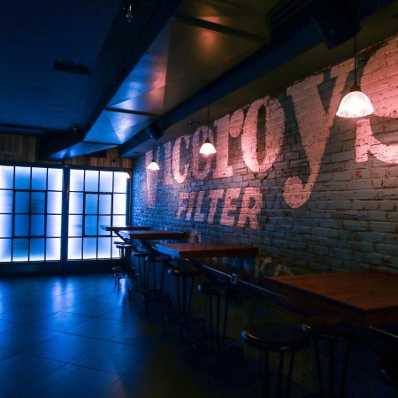 Blue-tinted underground bar area