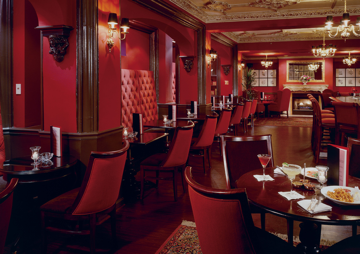 Dining room fully decked out in red furniture and walls.