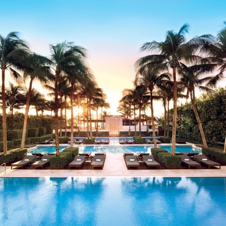 Pools with chairs and palm trees.