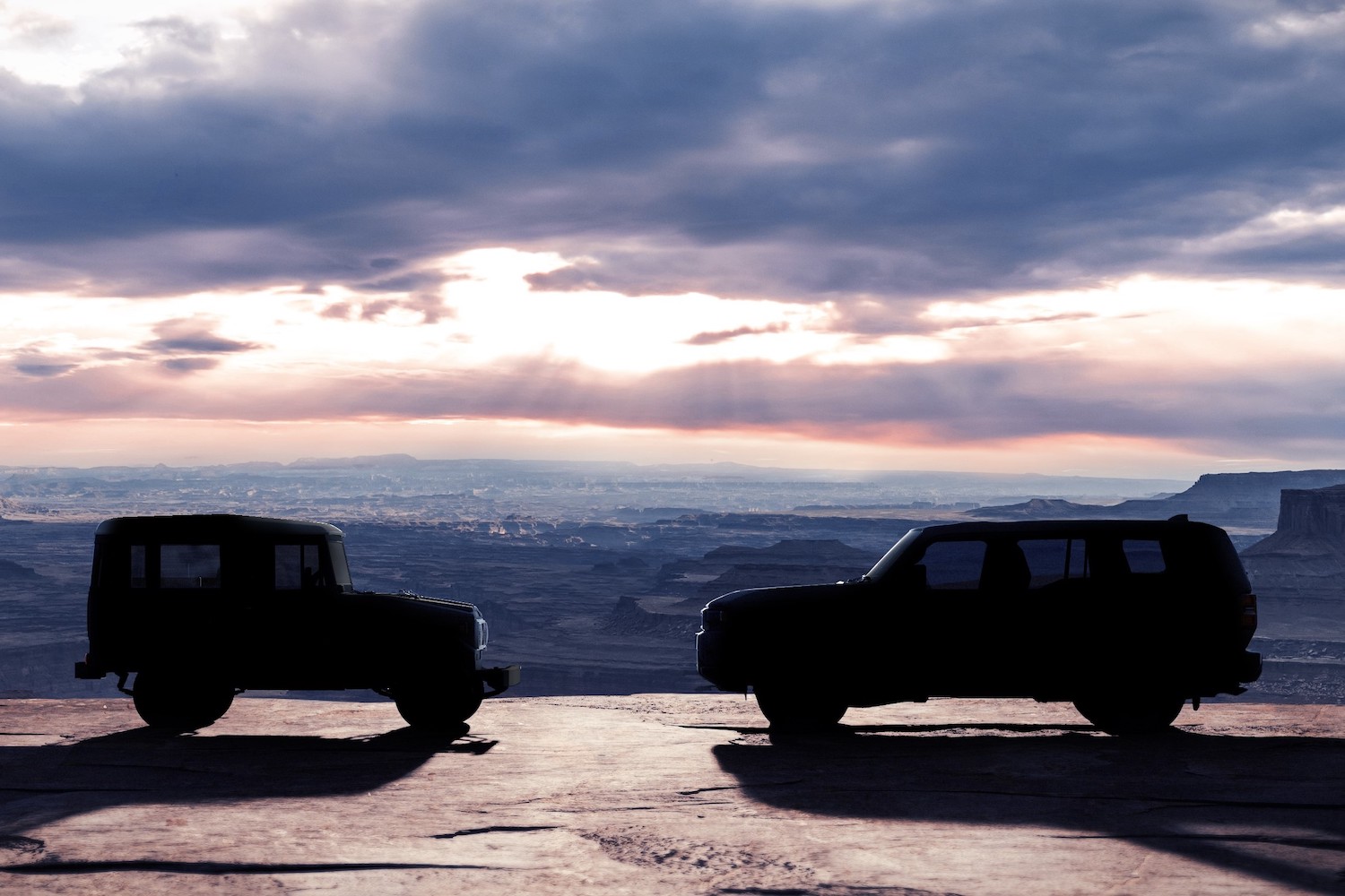 two cars facing each other on a mountain