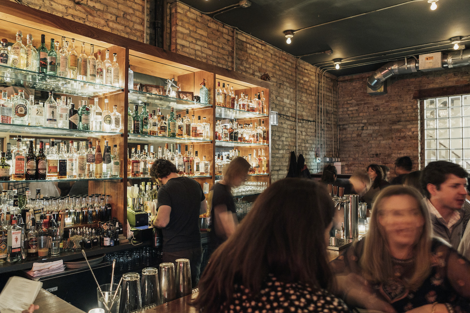 Busy bar area with bartenders making drinks