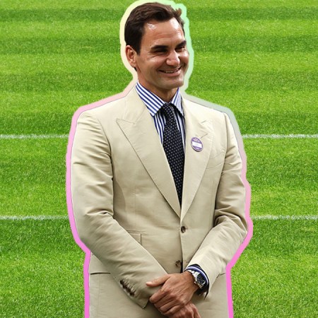 A photo of Roger Federer in a tan suit on a grassy court background