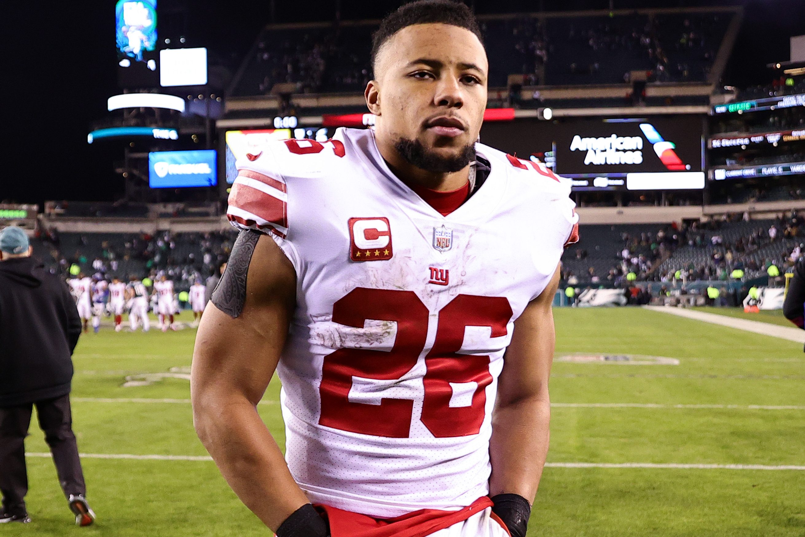 Saquon Barkley walks off the field after losing in the playoffs.